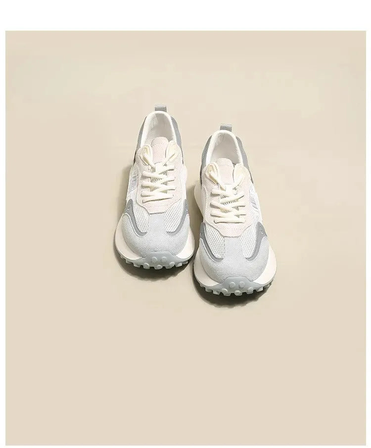 Women's pink and grey retro low-top sneaker with round toe and flat rubber sole.