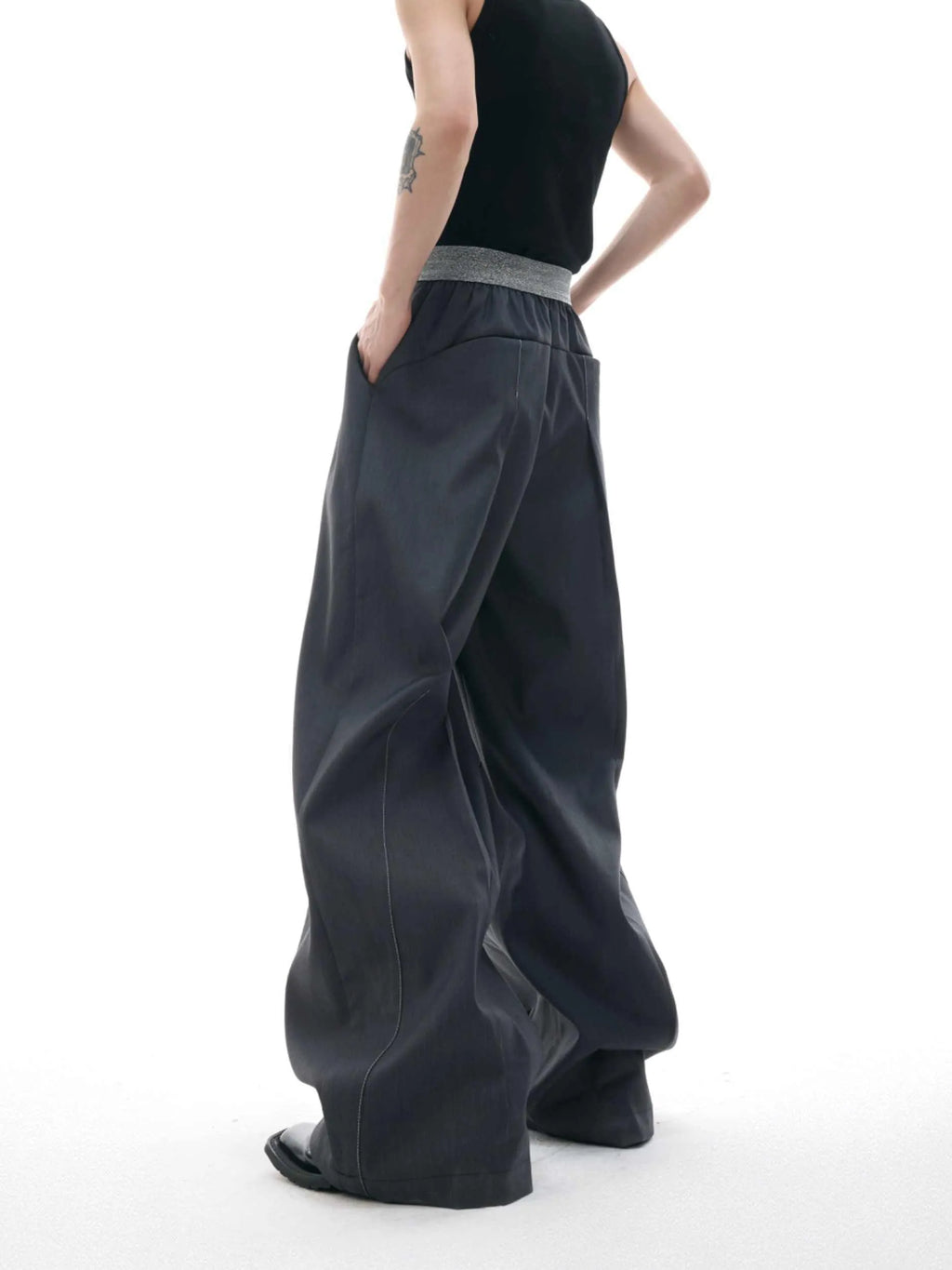 Men's straight-leg casual trousers with drooping design and button detail in black or grey