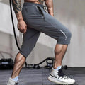 Men's quick-dry nylon cropped sports pants in black colour with straight-leg design