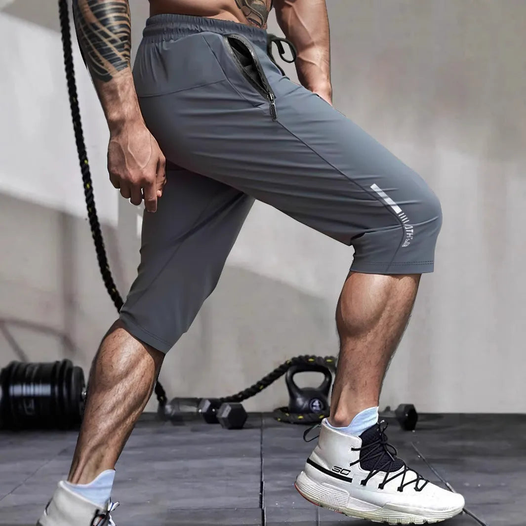 Men's quick-dry nylon cropped sports pants in black colour with straight-leg design