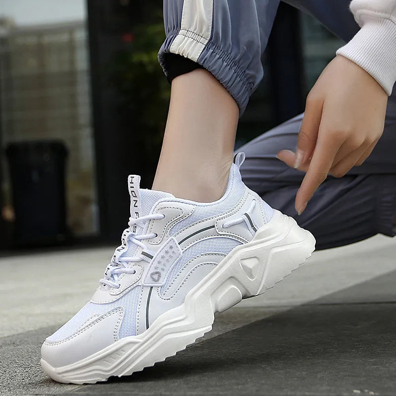 Women's white mesh casual sports shoes with a thick sole and a front buckle strap.