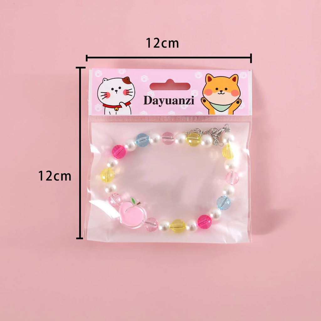 Colourful plastic bead pet necklace for a cat or dog in peach, rainbow, or small flower pattern.