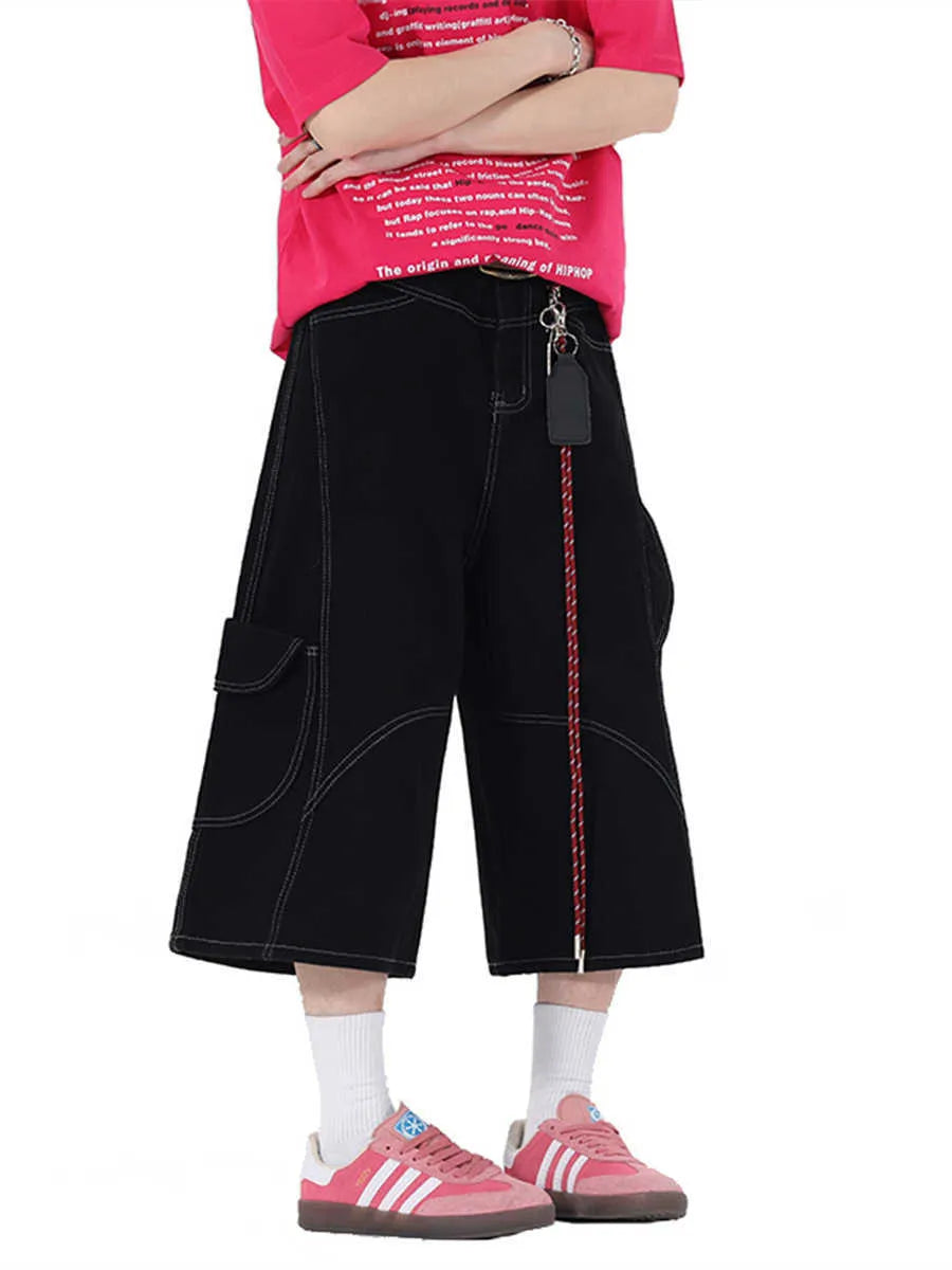 Retro black denim wide-leg shorts with multiple pockets on a mid-waist fit model.