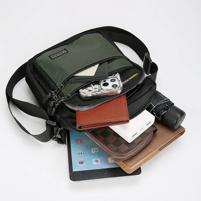 Men's nylon crossbody bag in solid colour with visible stitching, shown in green.