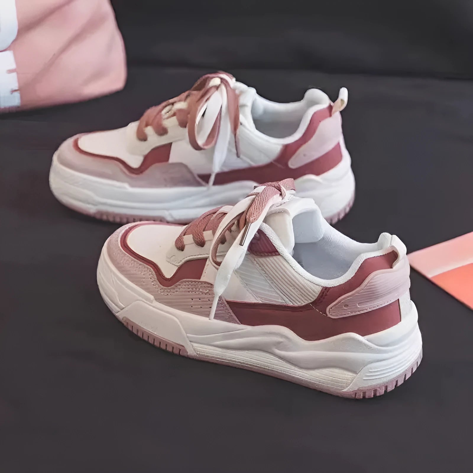 Women's pink and white low-top sneakers with a rubber sole, shown in sizes 35 to 40.