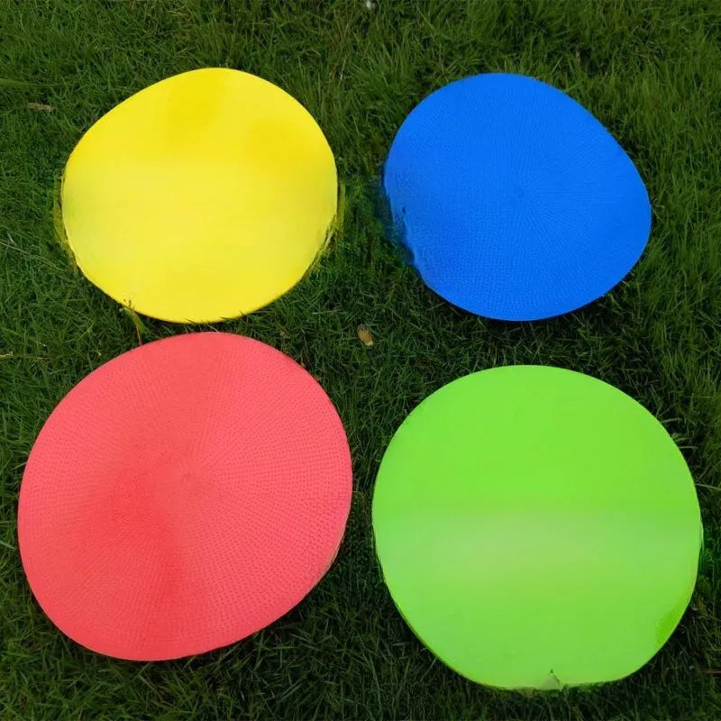 Yellow soft TPE football training target disc lying flat on grass