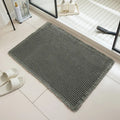 Square checkered pattern bathroom carpet on tiled floor in light grey colour.