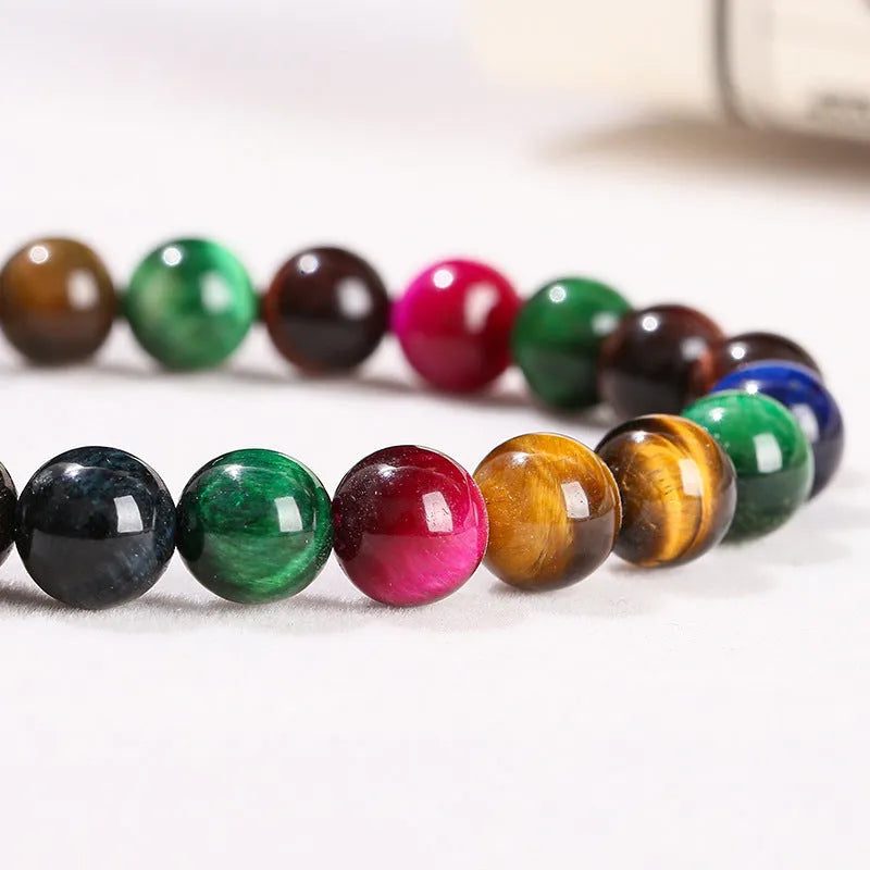 Colourful tiger eye bracelet with round beads in mixed sizes on a woman's wrist