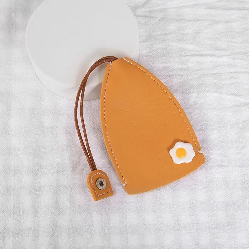 Colourful cartoon pull-out key protector case made from PU leather, showing a selection of fruit and animal designs.