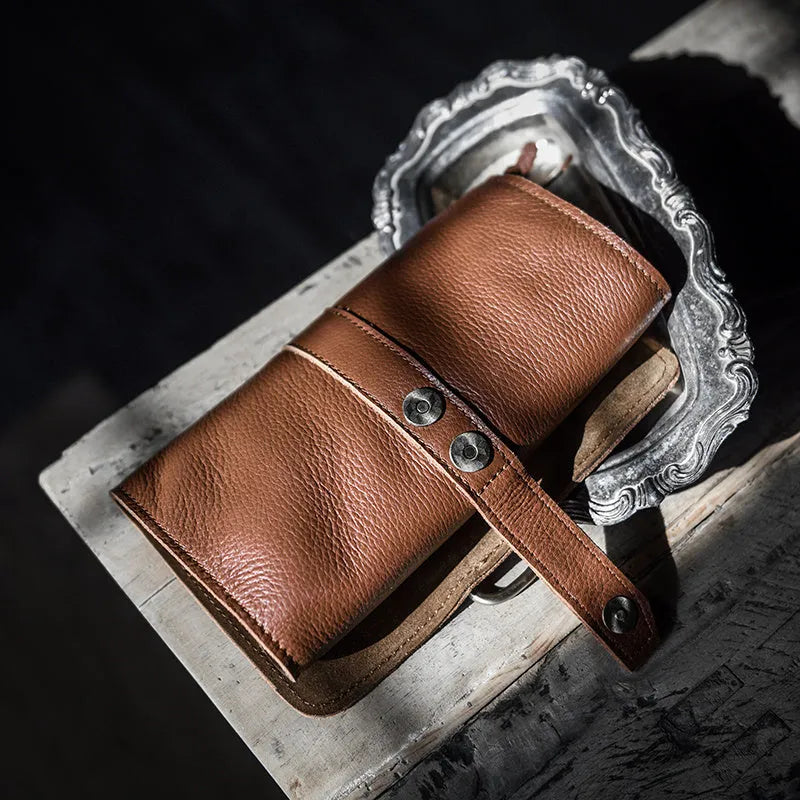 Handmade vintage cow leather wallet in black or dark brown with tape closure.