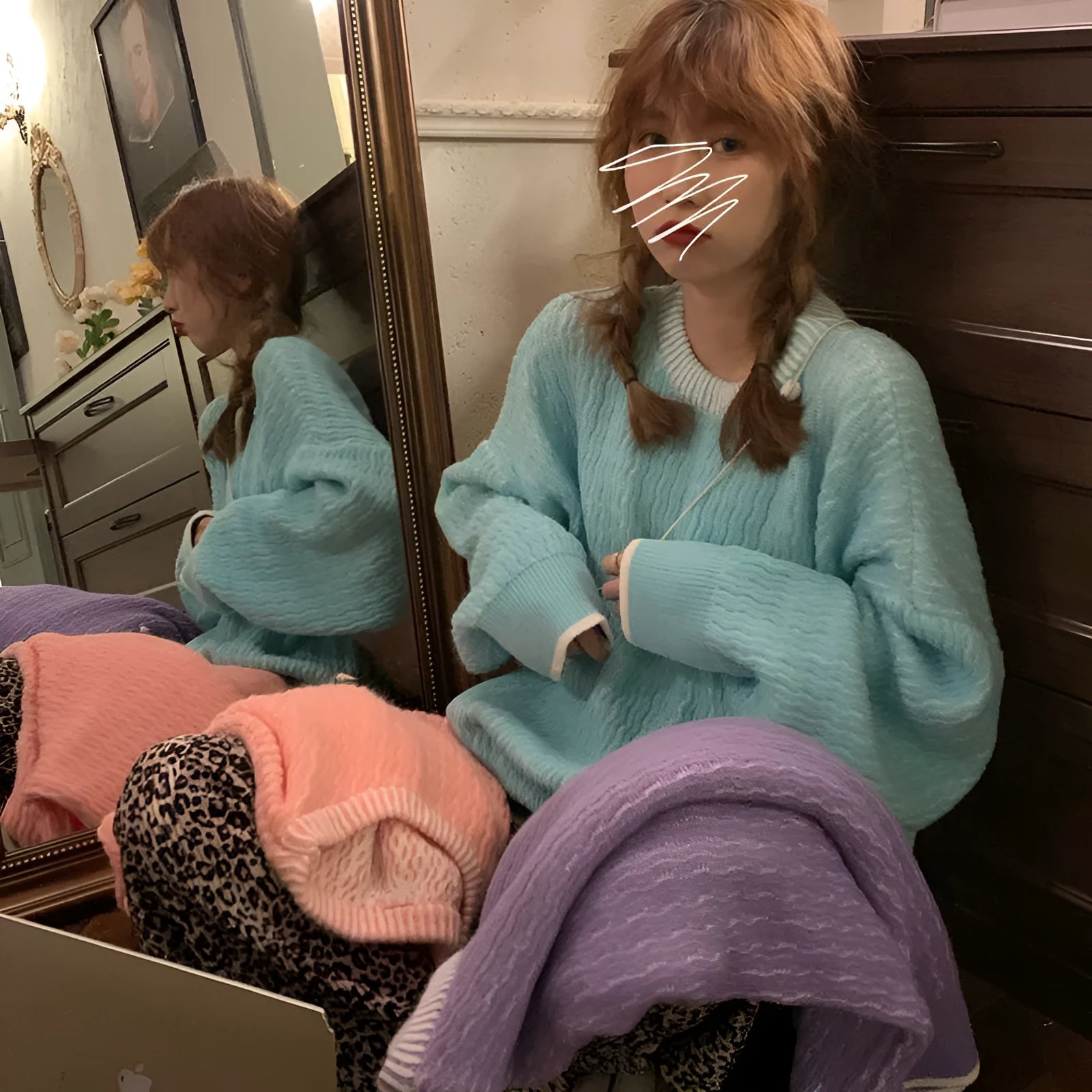 A woman's loose-fitting solid colour pullover sweater in a retro style, shown in lake blue.
