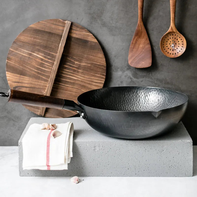 Traditional black iron wok with wooden handle measuring 32cm cooking surface diameter