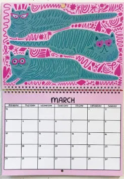 Cat themed wall calendar for 2024 or 2025, showing full year layout on paper.