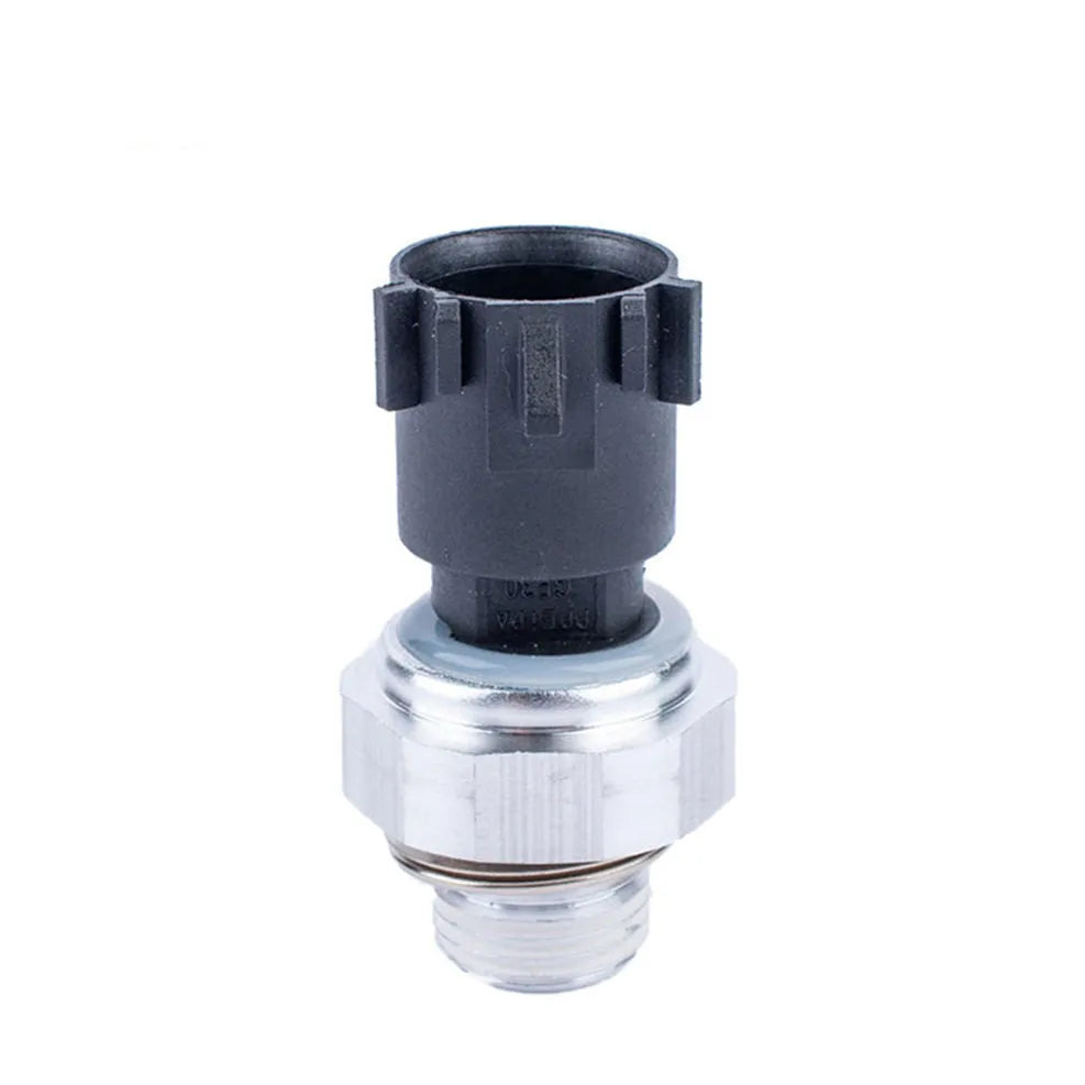Silver automobile fuel pressure sensor with electrical connector isolated on white background.