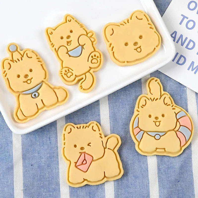 Plastic biscuit mould with puppy cartoon designs including birthday hats and swimming rings