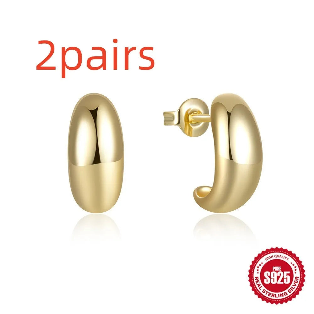 Sterling silver C-shaped stud earrings with glossy electroplated finish in gold or white gold
