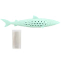 Green silicone fish-shaped cat chew toy with side holes on a white background