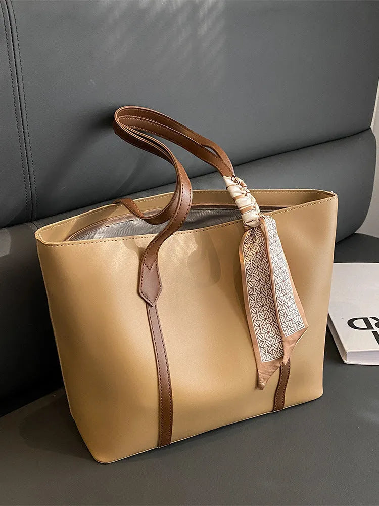 Soft women's crossbody tote bag in bucket silhouette showing sandwich pocket detail and shoulder strap