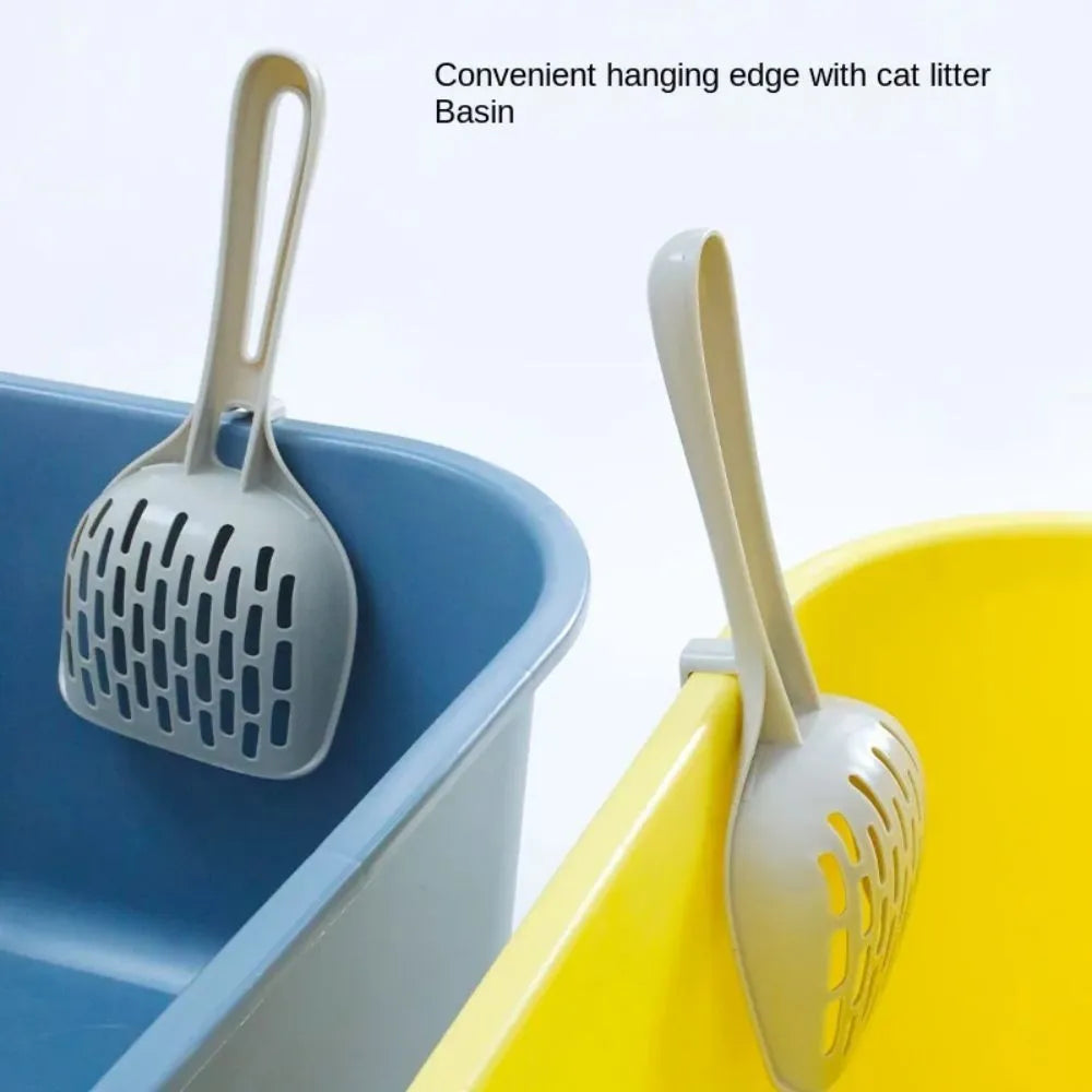 Grey plastic cat litter scoop with perforations, shown sitting on its attached square base stand.