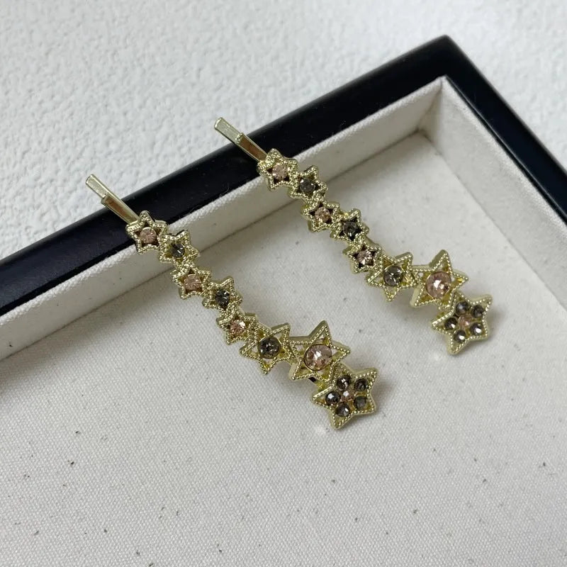 Gold electroplated alloy rhinestone barrette with star charm decoration