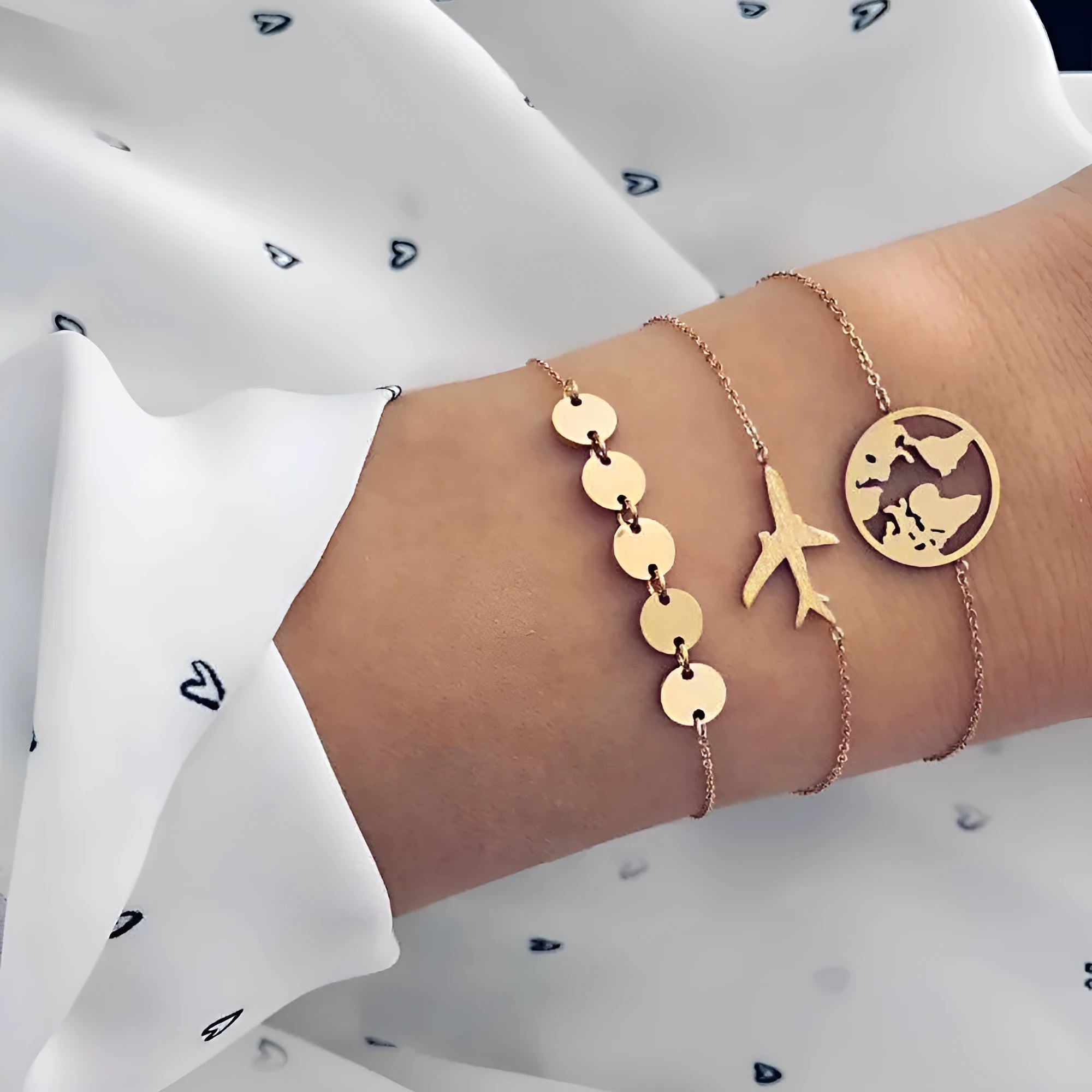 Set of three women's alloy bracelets with heart-shaped aircraft map charms.