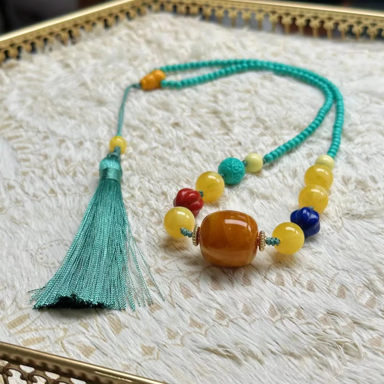 Turquoise mesh flower lucky pendant on an adjustable ball bead necklace, 71-80cm long.