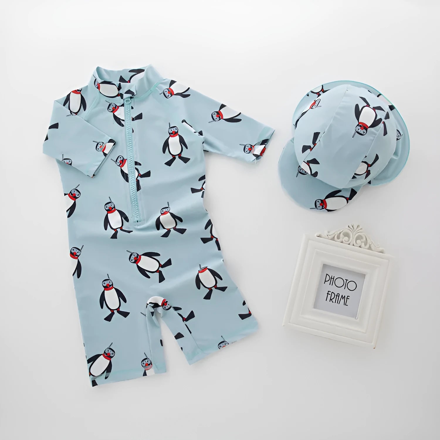 Boy's penguin themed long sleeve swimsuit with matching swimming cap for sun protection