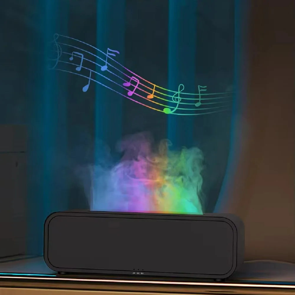 Black USB aroma diffuser with colour-changing LED lights and remote control on a wooden table.