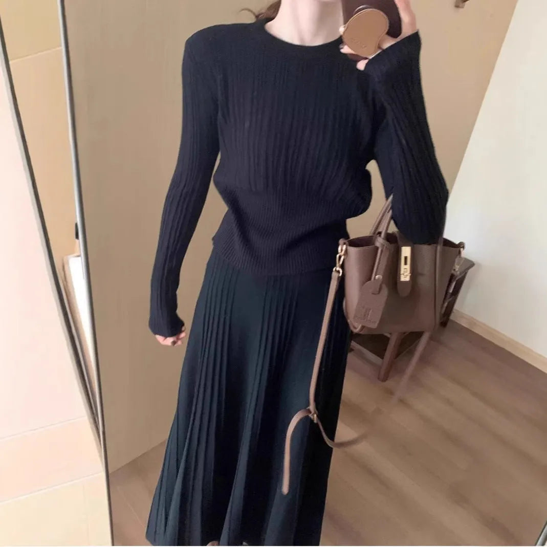 Women's dark grey knitted dress suit with 3D patterning and ethnic collage stitching, showing sweater and skirt two-piece set