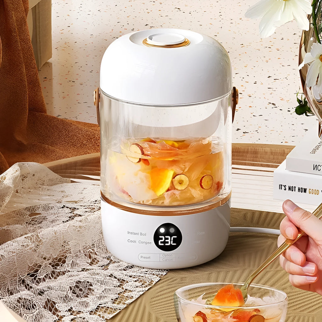Smart portable electric stew cooker with transparent glass lid showing food inside, on a kitchen counter.