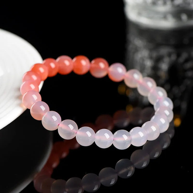 Natural gradient Yanyuan agate bracelet with smooth geometric beads on a wrist.