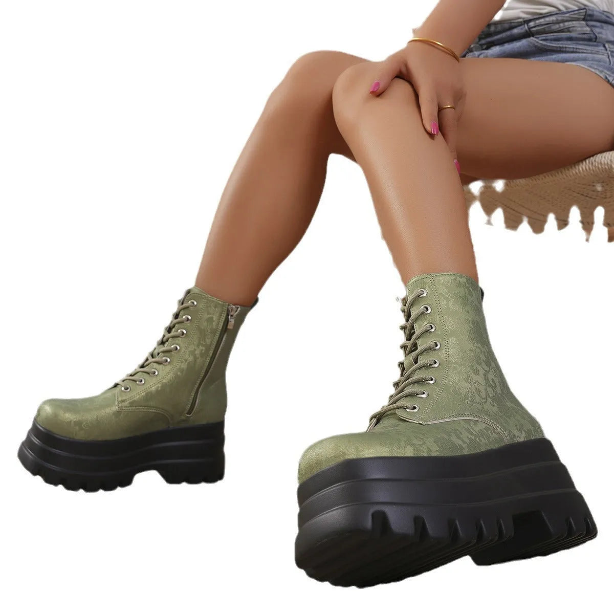 Women's black platform Martin boots with chunky heel and side zipper on a white background.