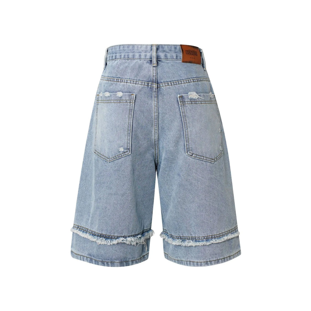 Distressed denim shorts with raw-edge hems in black, shown in a straight-leg cropped fit.