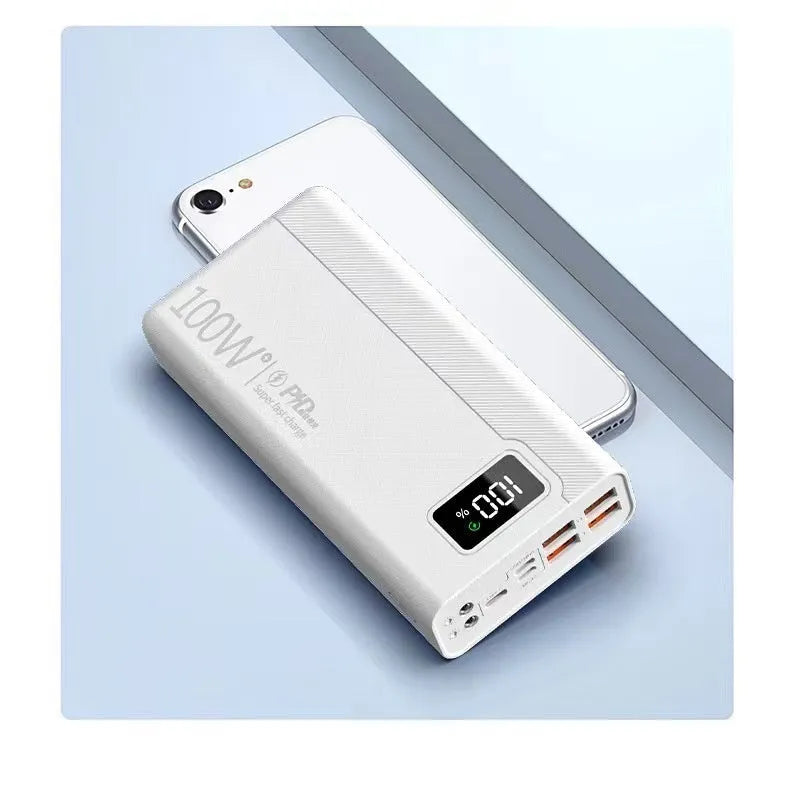 Black and white large capacity power bank with fast charging support, showing size scale.