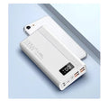 Black and white large capacity power bank with fast charging support, showing size scale.