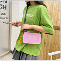 A transparent square jelly crossbody bag with a single adjustable shoulder strap.