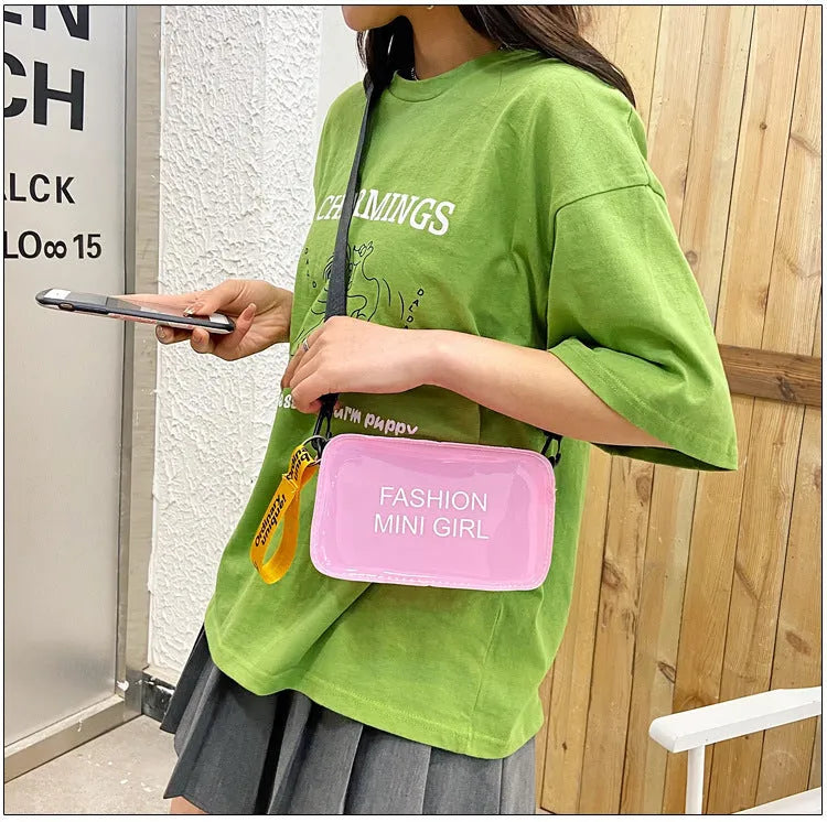 A transparent square jelly crossbody bag with a single adjustable shoulder strap.