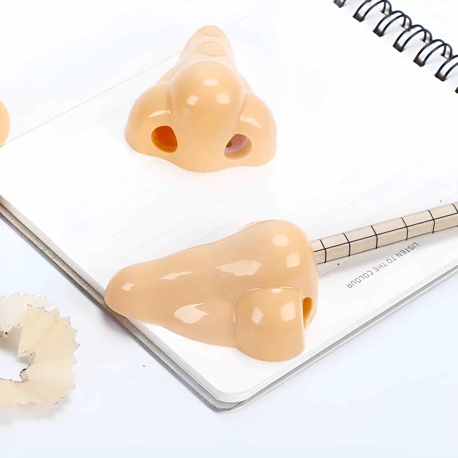 Flesh colour plastic pencil sharpener with large nostril opening for students