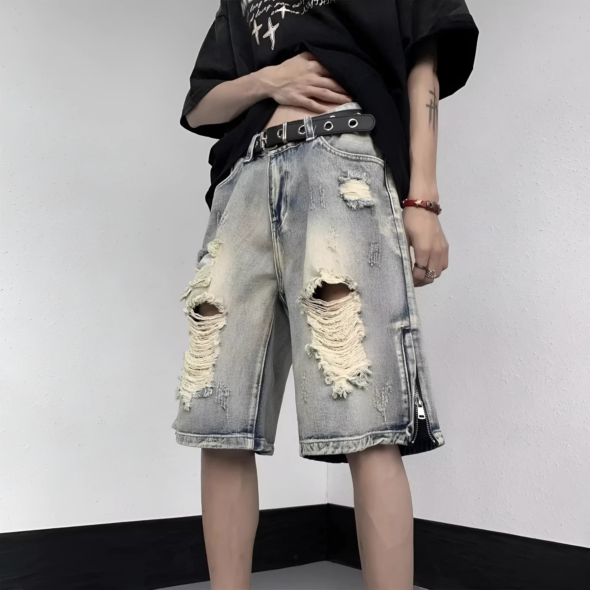 Blue retro denim shorts with a wide-leg loose fit and tattered detailing on a mannequin.