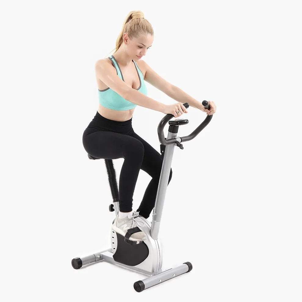 Grey spinning fitness bicycle with steel frame and foam handlebars for home office cardio training