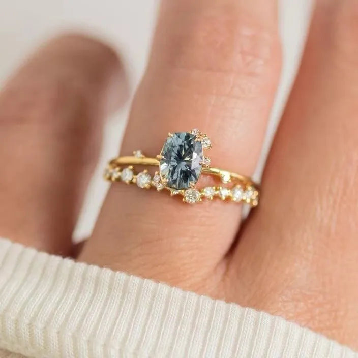 Gold plated floral women's ring with a central green zircon stone.