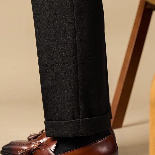 Men's black leather tassel loafers with polished finish and rubber soles for business casual wear