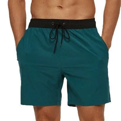 Men's blue training shorts with stitching waist detail and headband pocket