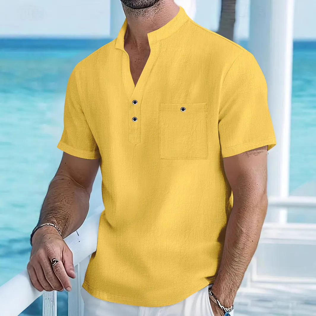 Man wearing a light apricot-coloured linen blend T-shirt with a stand collar and short sleeves.