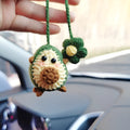 Handmade crocheted wool car pendant with a cartoon flower in avocado, pink rainbow, or red rainbow colours.
