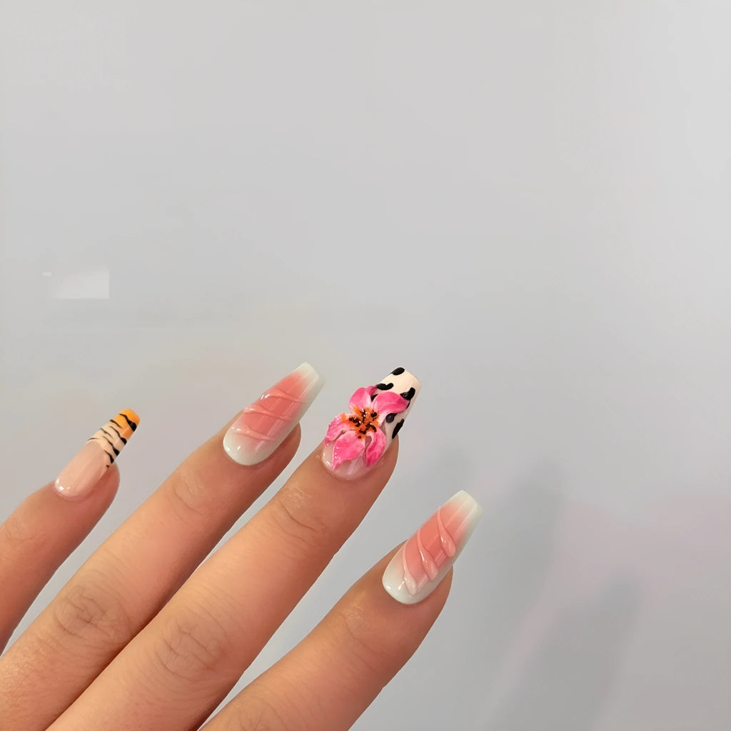 Close-up of zebra pattern artificial nails with embossed lily flower and leopard print designs, shown in long wear-resistant style.