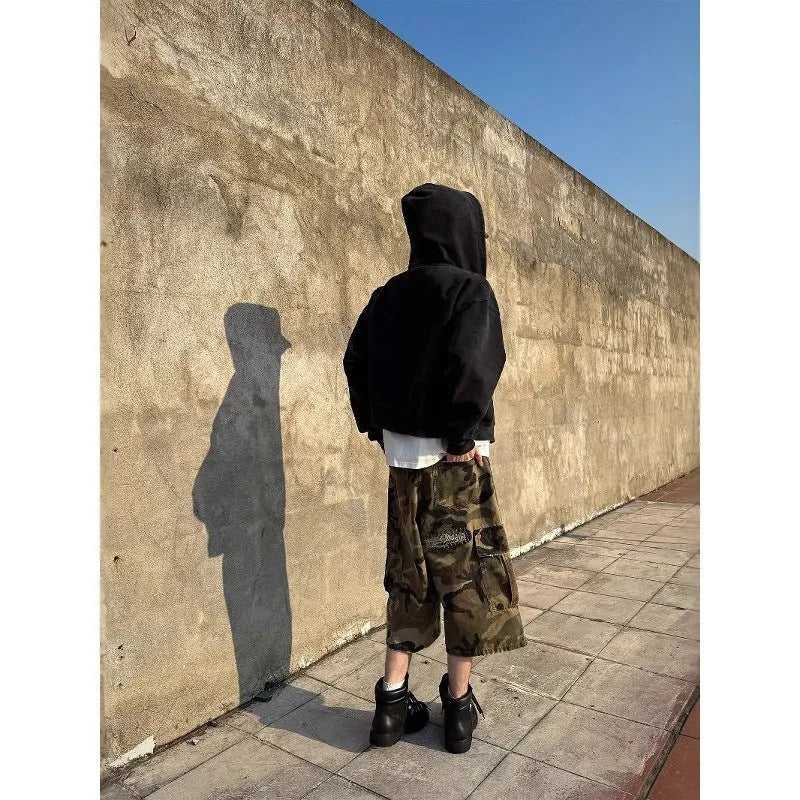 Men's camouflage cropped jeans with retro patches and ripped detailing on straight leg trousers