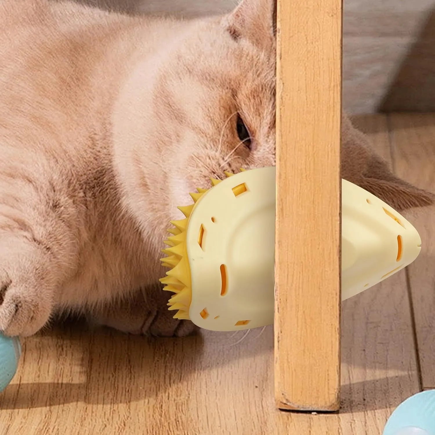 Yellow durian-shaped cat corner scratcher with spiky texture mounted on a wall