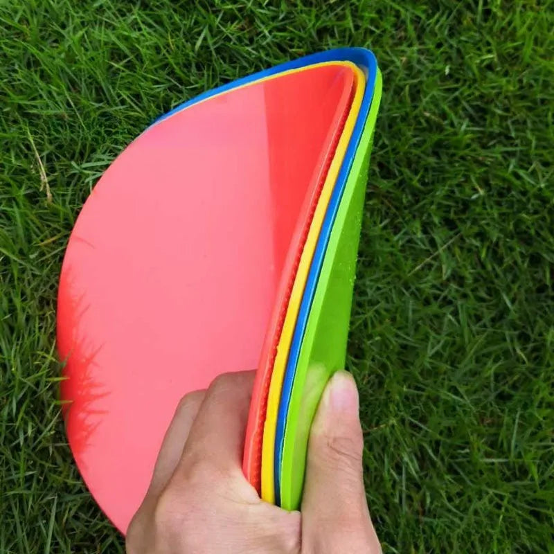 Yellow soft TPE football training target disc lying flat on grass