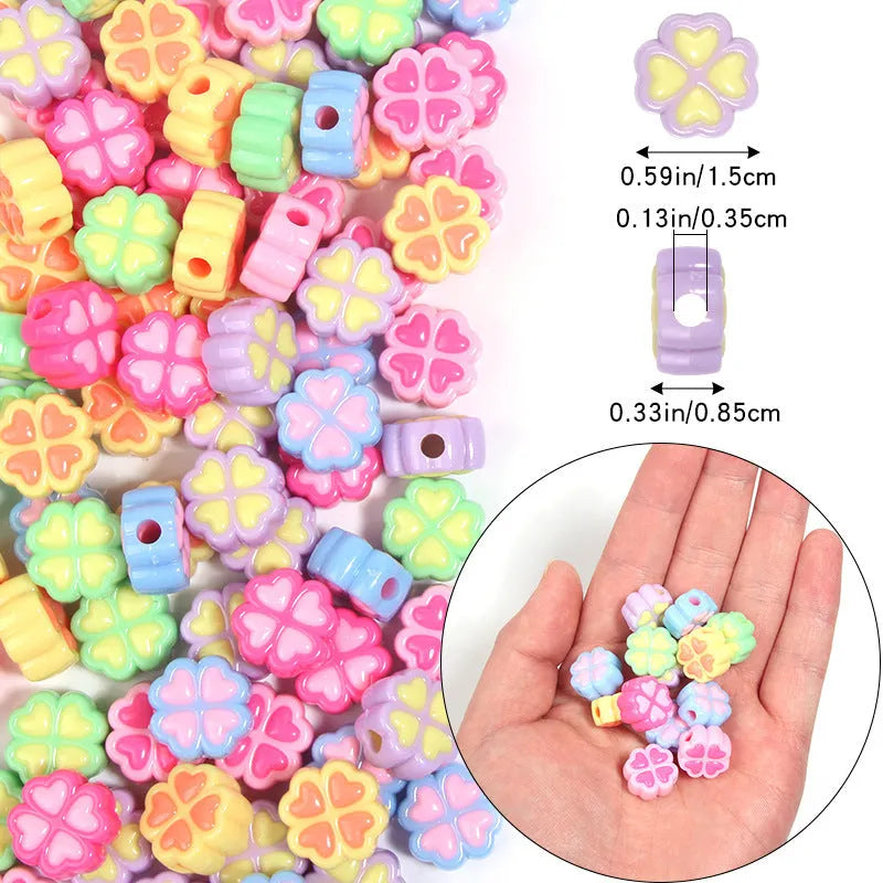 Mixed colour frosted acrylic four-leaf clover shaped beads, each 15mm in size.